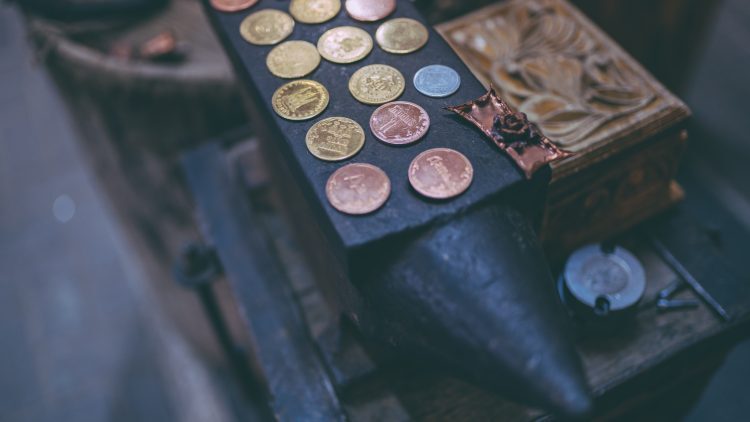 Close up hand putting coin in stack of coins with miniature house, The ...